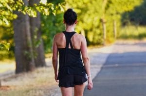 young fitness woman walking in the forest