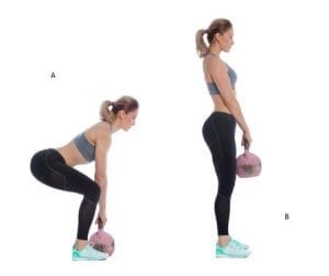 Young woman squatting with kettlebel