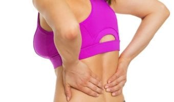 woman holding her sore back