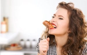 Woman eating a sausage