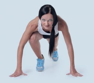 Interval training for beginners - kneeling woman about to sprint