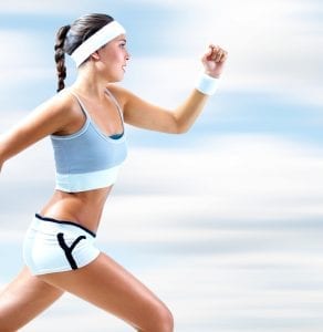 Young, fit woman sprinting on the beach