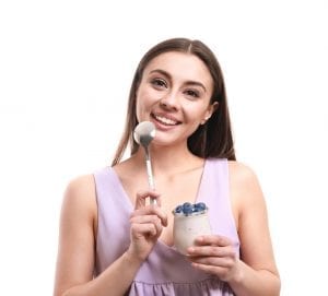 Fast weight loss tips - woman eating yogurt and berries