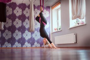 Young woman doing aerial yoga