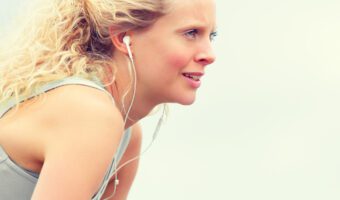 YOung, blonde women exercising wearing ear pods