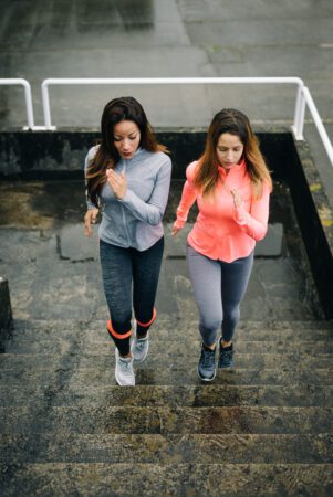 Urban fitness women running and climbing stairs