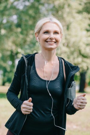 Blond woman jogging in a park