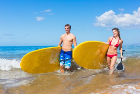 Board riders in the surf