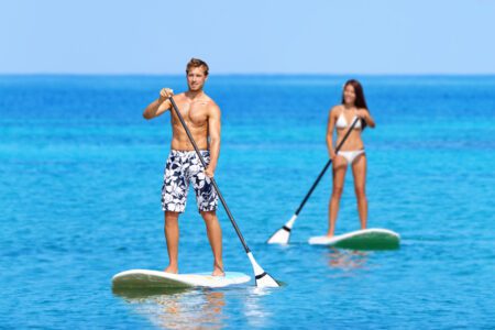 man and woman paddling stand-up paddle boards