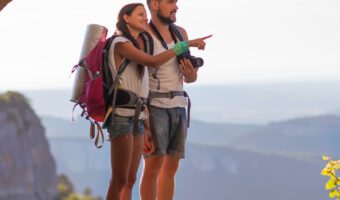 Young couple admiring the scenery while hiking