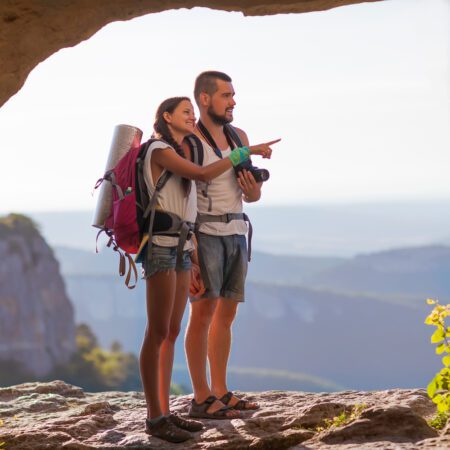 Young couple admiring the scenery while hiking 