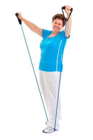 Senior woman using a resistance band while standing