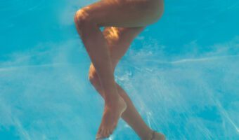 Woman jogging in a pool wearing a bikini