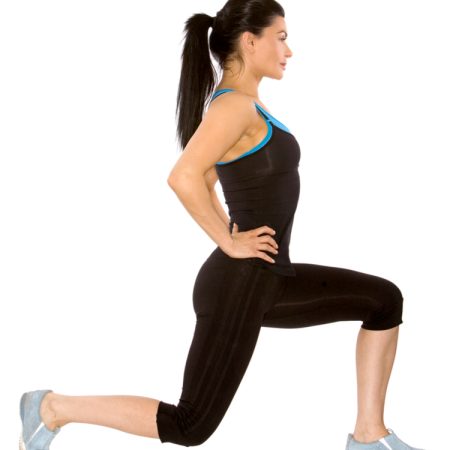 Profile view of a brunette fitness model doing lunging exercise